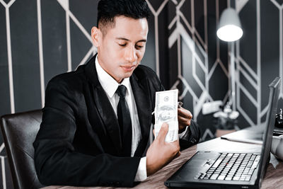 Midsection of man sitting on table