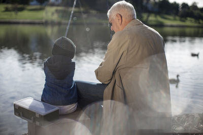 Grandfather and grandson fishing together