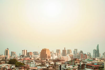 Modern buildings in city against clear sky