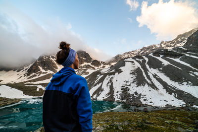 Rear view of man standing against mountain