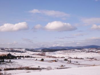 Scenic view of snowcapped landscape against sky