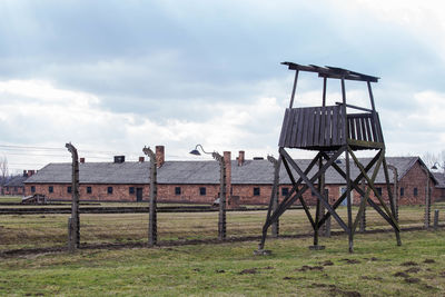 Traditional windmill on field against sky