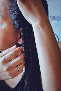 Close-up portrait of woman with hands in water