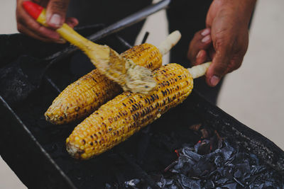 Cropped hand of man holding food