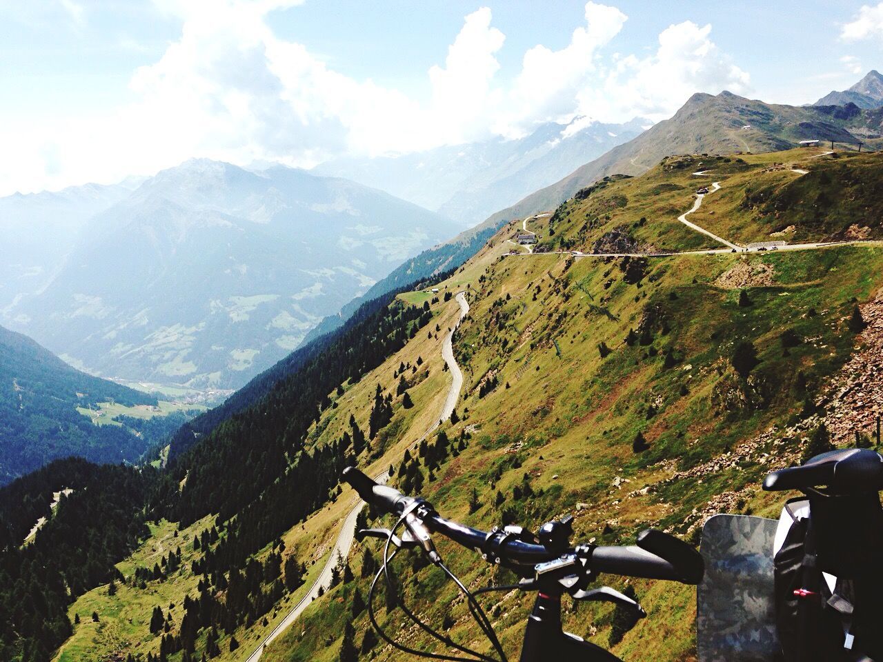 mountain, mountain range, scenics, sky, beauty in nature, tranquil scene, tranquility, landscape, transportation, nature, mode of transport, green color, non-urban scene, cloud - sky, idyllic, land vehicle, high angle view, day, cloud, travel