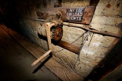 High angle view of old machine part on wooden floor