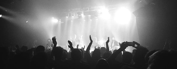 Close-up of silhouette people at music concert