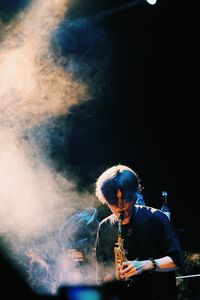 Man holding cigarette at night