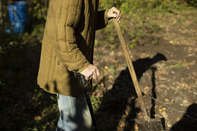 Rear view of woman standing on field