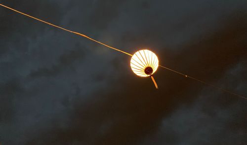 Low angle view of illuminated lighting equipment against sky at night