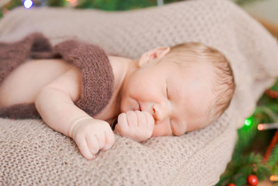 A cute newborn baby sleeps on a knitted bedspread, a healthy and cute baby