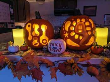 Jack o lanterns on table with festive fall decor