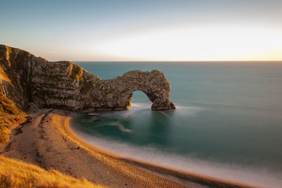 Long exposure of the calm sea at durdle door at dusk