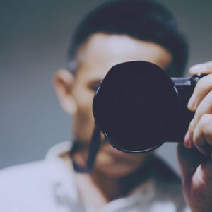 Close-up of man photographing