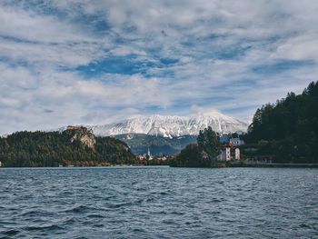 View of the snow-capped mountain peaks against the lake bled.