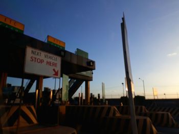 Close-up of road sign against sky