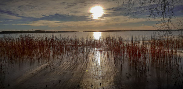 Scenic view of lake against sky during sunset