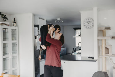 Mother kissing daughter