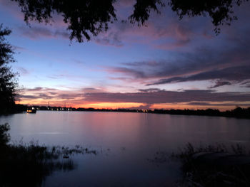 Scenic view of lake against sky at sunset