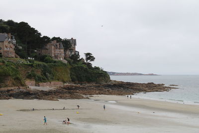 People on beach against sky