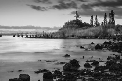 Scenic view of river against cloudy sky