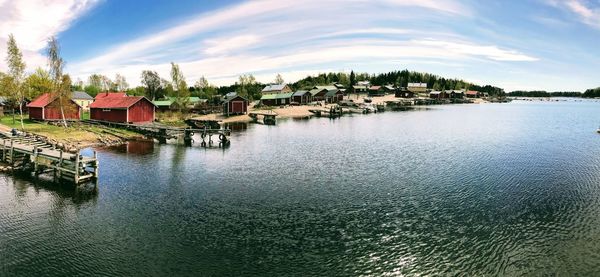 Panoramic view of canal amidst buildings against sky