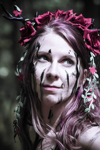 Portrait of beautiful woman with red flower