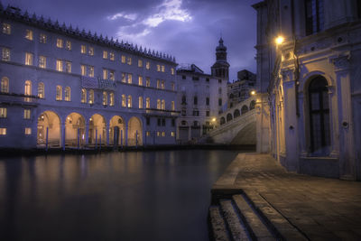 Reflection of illuminated buildings in city at night