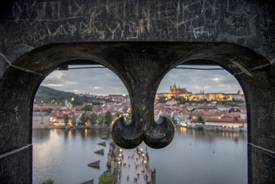 Arch bridge over river in city