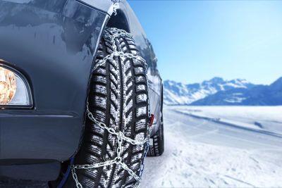 Close-up of car on snowy field during winter