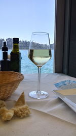 Glass of wine bottles on table