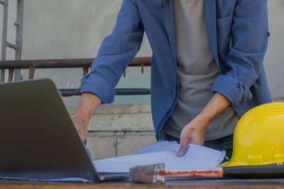 Low section of man working on table