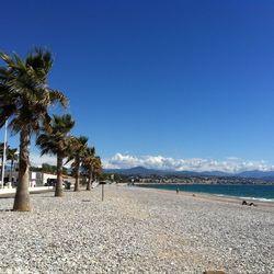 Scenic view of beach against clear blue sky