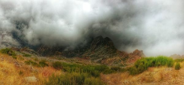 Scenic view of landscape against cloudy sky