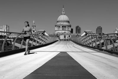 View of bridge against clear sky in city