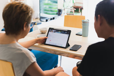 Couple working on laptop computer at home.