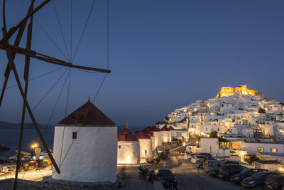 Illuminated village houses against sky