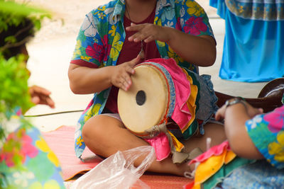 Midsection of street musicians performing on road 