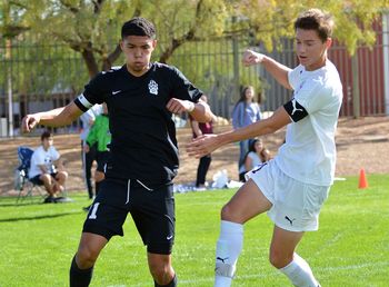 Men playing soccer on field