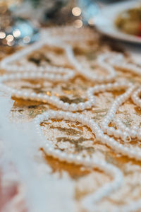 Close-up of bead necklace on table