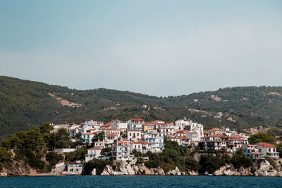 Townscape by sea against clear sky