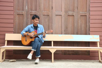 Full length of man playing guitar