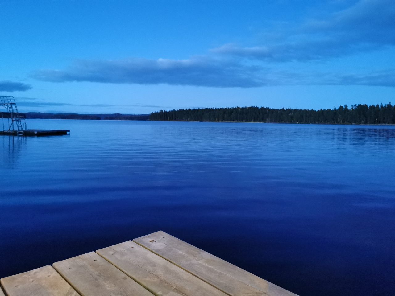 PIER ON LAKE AGAINST BLUE SKY