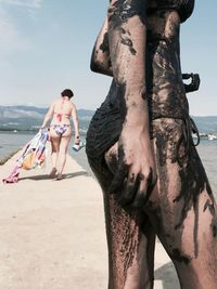 People at beach against sky