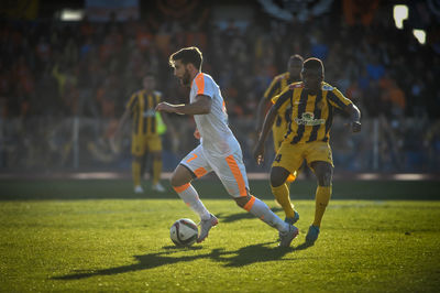 Man playing soccer on grass