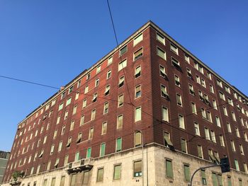 Low angle view of buildings against clear blue sky