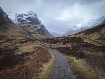 Road amidst mountains against sky