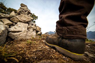 Low section of man standing on rock