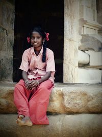 Young woman standing in front of building