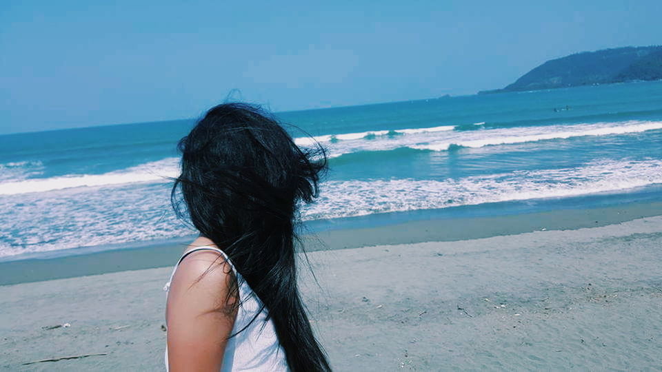 sea, horizon over water, beach, water, lifestyles, clear sky, shore, leisure activity, scenics, person, beauty in nature, tranquility, tranquil scene, nature, vacations, long hair, idyllic, sky